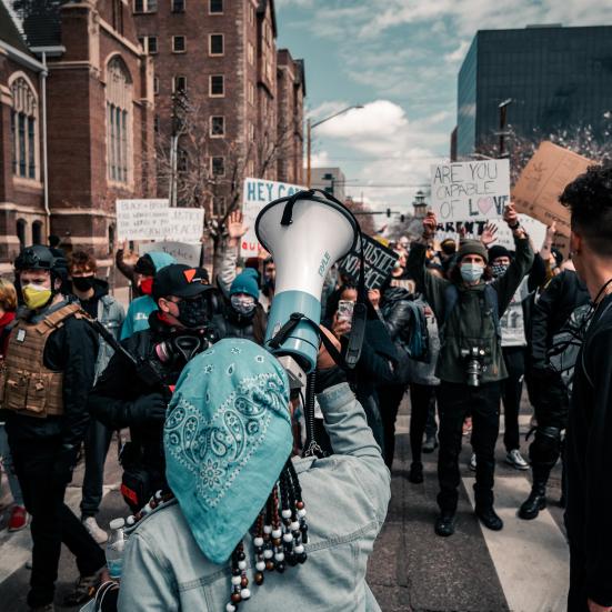 Demonstration med megafon og løftede skilte
