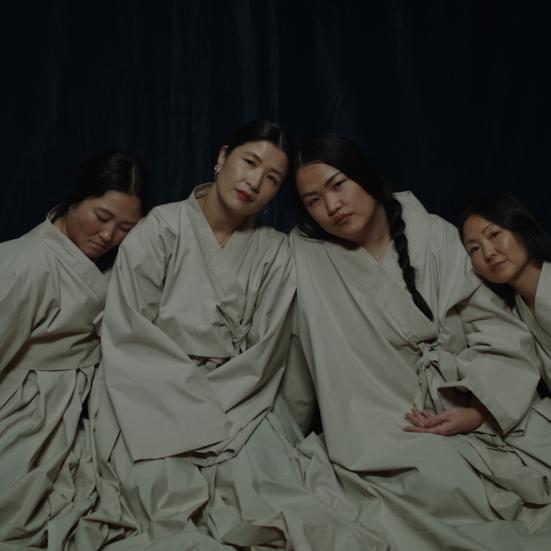 Fotoet er et stillbillede fra filmen. Det viser fire koreanske kvinder, der læner sig op ad hinanden 